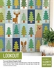 LOOKOUT Quilt Pattern  shows a quilt featuring  a bear, deer, and rabbit hiding among the  evergreen forest in a charming quilt design.