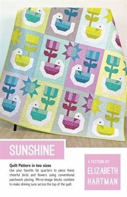 SUNSHINE Quilt Pattern  shows a quilt featuring  cheerful birds and flowers in a soft pastel color palette of yellows, blues, teals, mustard and purple.