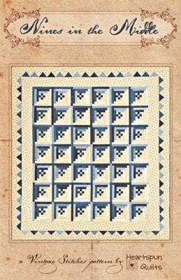 Nines in the Middle  Quilt Pattern by Heartspun Quilts featrues and blue and white log cabin variation that has a nine patch in the center of the block and a flying geese border frame.