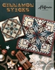 Cinnamon Stick Quilt Pattern by Judy Niemeyer shows are large 8 pointed star design with a central swirling motif.