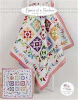 Birds of a Feather Quilt Pattern by Jillily Studio shows an applique sampler quilt done in bright solid fabrics.