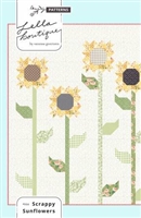 Scrappy Sunflower Quilt Pattern by Lella Boutique depicts pretty, tall sunflowers growing tall in the field.
