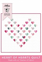 Heart of Heart Quilts Pattern by Melissa Mortenson shows a pretty, delicate heart quilt where the large heart is created by smaller heart blocks in shades of soft pink and green on a white ground.