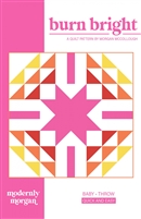 This is a very graphic quilt design with a center star surrounded by half square triangles in bright pinks, red and orange on a white ground.