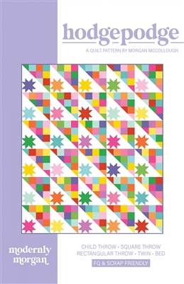 Bright colorful quilt features a bright star on a white ground for half the block, and bright colorful squares and half square triangles making up the other half of the block.