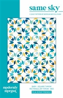 This allover quilt design features stars and diamond shapes in shades of blue, with yellow accents on a white ground.