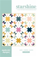 Scrappy quilt features large star blocks with minimally pieced alternate blocks in a colorful design made from fat quarters.