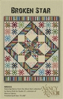 Broken Star Quilt Pattern from Nancy Rink Designs features a large center medallion star, combined with star and log cabin blocks and a scrappy piano key border in a colorful array of colors.