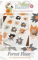 This quilt depicts graphic fall leaves as a quilt block, in a modern interpretation of grays and pumpkin , from The Pattern Basket