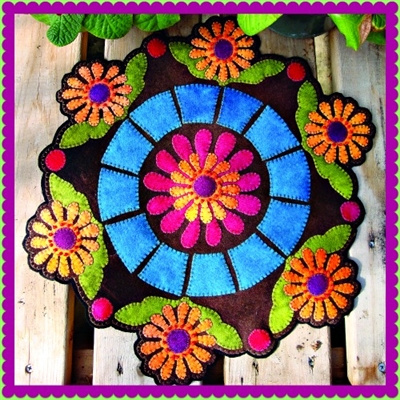 Lazy Daisy Summer Afternoon floral candle mat or penny rug showcases  beautifully designed applique crafted in buttery soft hand dyed wool in vibrant color.