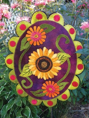 Sunflower framed by Zinnias in Seasonal Accent  wool applique wall hanging or penny rug pattern, handsomely crafted in buttery soft, hand dyed wool in vibrant color.