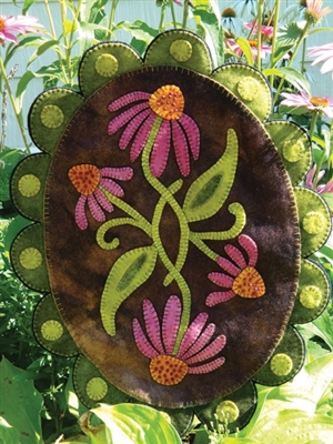 Purple coneflowers craft a stunning seasonal home accent sewn in wool applique as a wall hanging or penny rug pattern,  shown in buttery soft, hand dyed wool in vibrant botanical colors.
