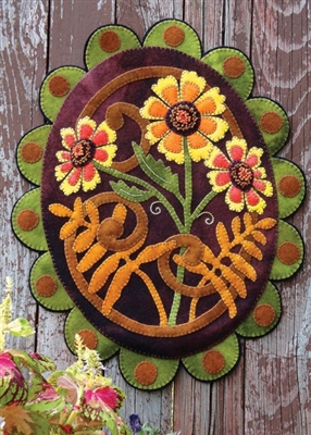 Sunflower framed by Zinnias in Seasonal Accent  wool applique wall hanging or penny rug pattern, handsomely crafted in buttery soft, hand dyed wool in vibrant color.